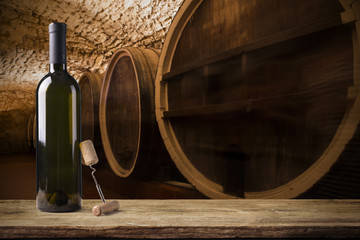 Red wine with barrel on vineyard in green Tuscany, Italy