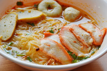 thin noodle with fish ball and red barbecue pork in Tom Yum soup