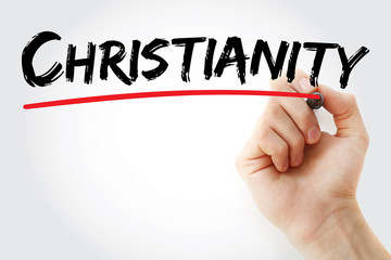 Hand writing Christianity with marker, concept background