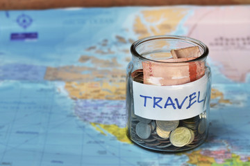 Travel budget concept. travel money savings in a glass jar