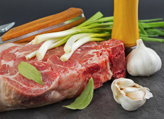 Piece of pork meat on a black stone table