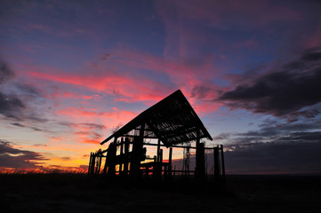 Silhouette hut at vanilla sunset. Beautiful natural background.