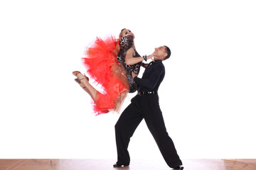 Latino dancers in ballroom against white background