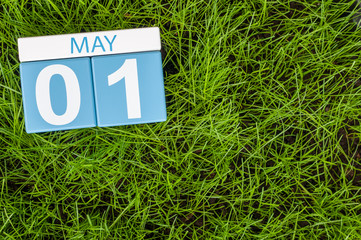 May 1st. Day 1 of month, calendar on football green grass background. Spring time, empty space for text