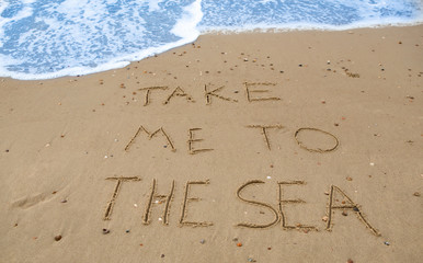 take me to the sea, written in the sand at the beach