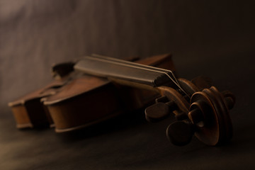 Old broken violin on black background