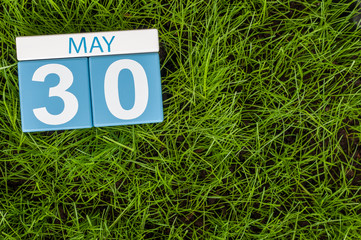 May 30th. Day 30 of month, calendar on football green grass background. Spring time, empty space for text