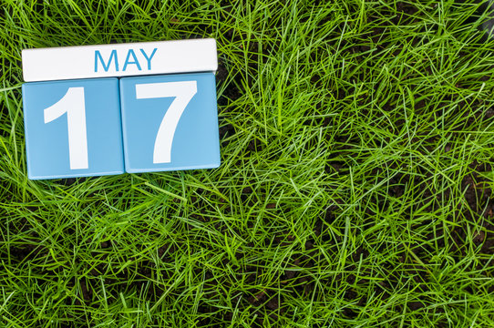 May 17th. Day 17 of month, calendar on football green grass background. Spring time, empty space for text
