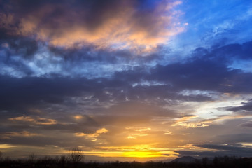 Naklejka na ściany i meble Landscape Dramatic sunset and sunrise sky with a silhouette of t
