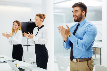 Business people clapping hands at meeting