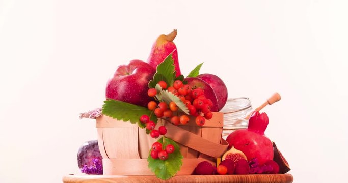 Still life fruits composition rotation 4k looped video. Red food in basket isolated on white background