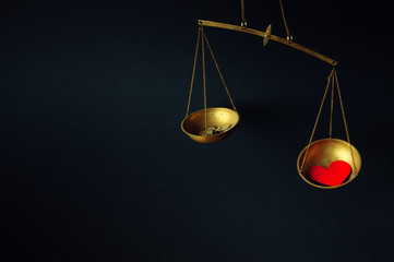 Old fashioned scale showing the advantage of love over money
