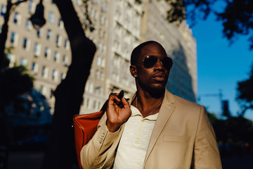 Young Black Businessman Walking on the Streets of Manhattan . New York City