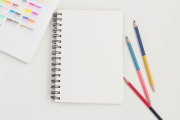 Top view of art supplies on white table. 