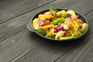 Frying pan with roasted chicken and vegetables