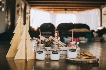 three containers of milk and cookies, winter scenery, family
