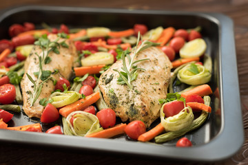 Baked chicken with basil, carrot and cherry tomatoes