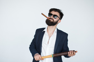 Portrait Of Young bearded man Holding Baseball Bat Over grey Background