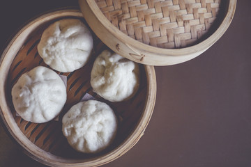 baozi chinese dumplings on bamboo steamer. with vintage filter. top view