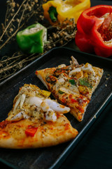 pizza seafood with cheese, tomatoes, green pepper, red pepper and yellow pepper. Rustic italian pizza