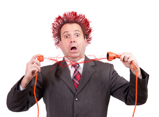 businessman is shocked from sparks from an electric plug connector