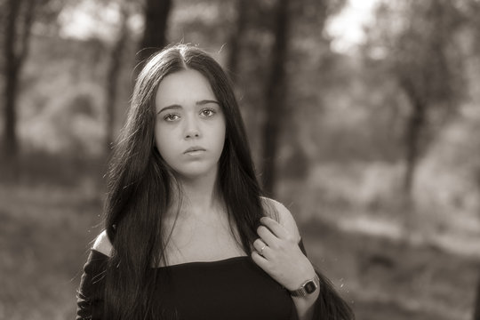 Portrait of young woman touching her hair.
