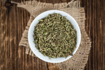 Old wooden table with dried Stevia leaves (selective focus)