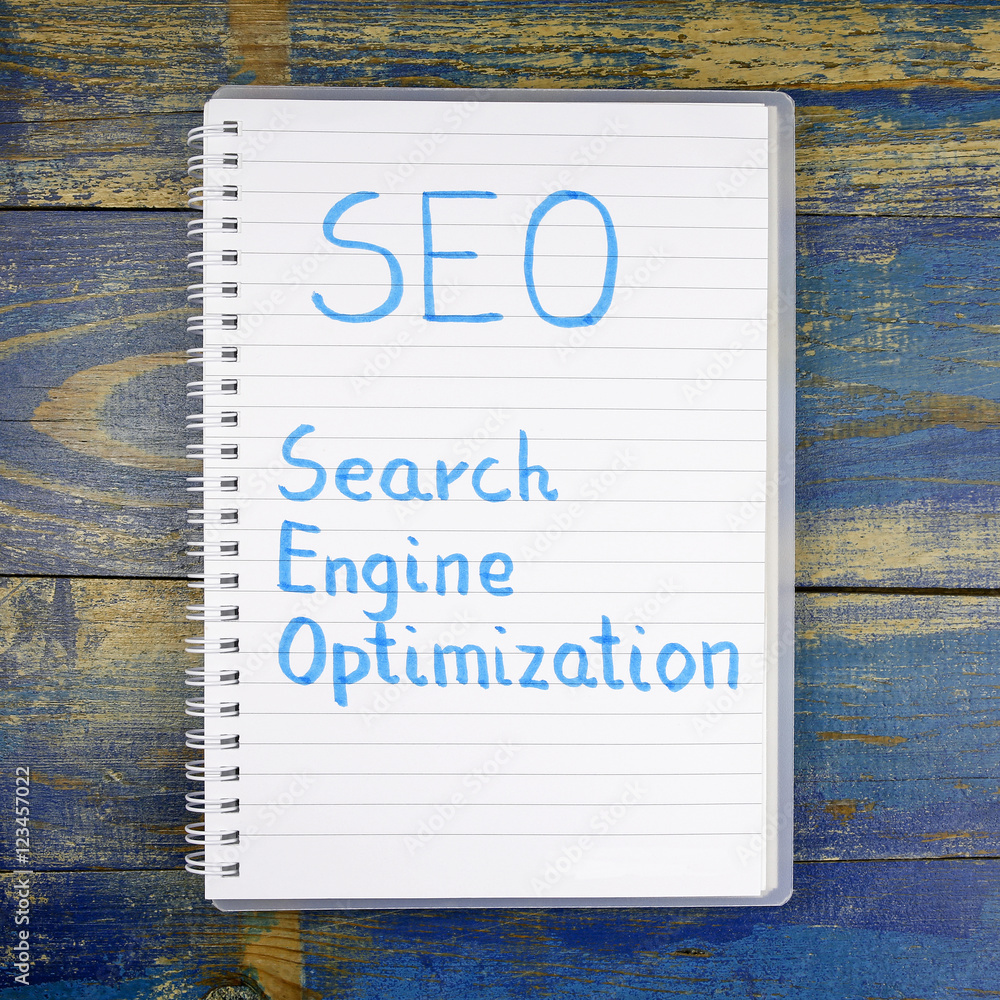 Poster seo- search engine optimization written in notebook on wooden background
