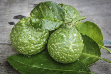 Bergamot with green leafs on wood background.