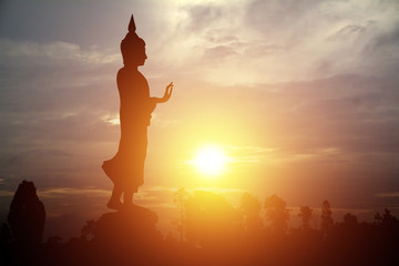 Silhouette of Buddha with sun shining