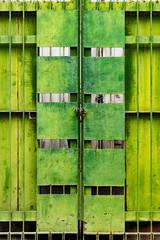 Tarnished green metal gate, Mandalay, Myanmar