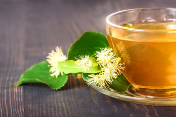 Linden tea in a glass cup close up.