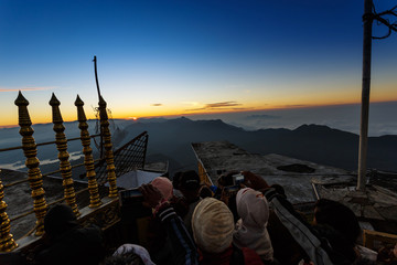 Sri Lanka, Southern Asia - February 14, 2015: Sunrise greeted pilgrims on the holy mount Adams Peak ( also Sri Pada ) is the most popular pilgrim place in Sri Lanka - obrazy, fototapety, plakaty