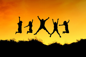 Fototapeta na wymiar Group of friends jump on the top of mountain and getting fun on mountains backdrop