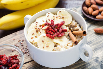 Oatmeal porridge with banana and cinnamon for healthy breakfast. Close up