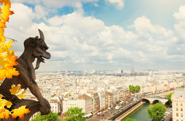 Gargoyle of Paris on Notre Dame Cathedral church and Paris cityscape with Eiffel Tower at fall day,...