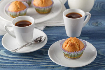 Three chocolate chip muffins on white plate and blue striped tab
