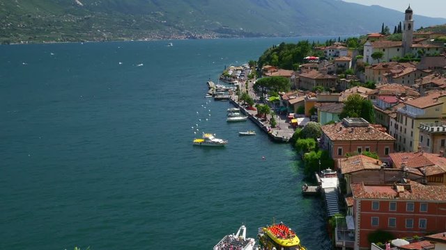 Ships moored at Limone Sul Garda pier in the Garda lake, Northern Italy.