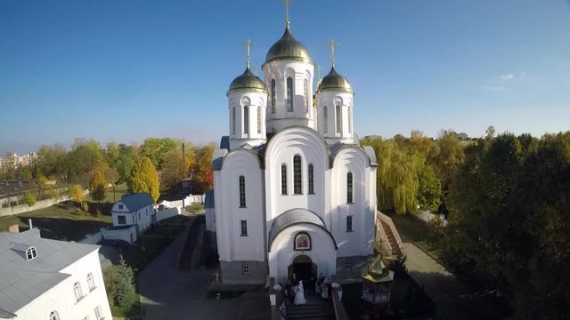 Newlyweds are at the front of Orthodox church