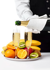 Waiter pouring champagne into glass