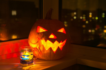 Glowing halloween pumpkin and cup