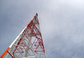 Newly completed telecommunication tower with white and red paint, step ladder