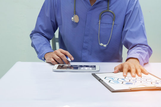 Doctor working with tablet at desk