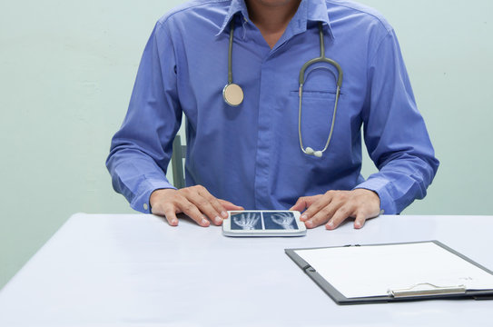 Doctor working with tablet at desk