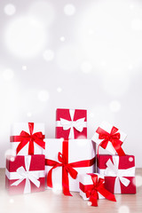 Christmas background - red and white gift boxes on wooden floor