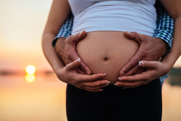 Holding her pregnant belly