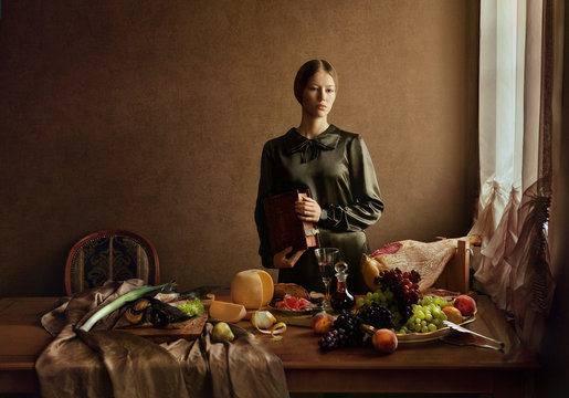 Woman wearing green clothing with still life of food and drink  
