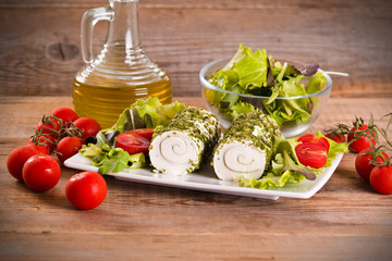 Goat cheese with salad and cherry tomatoes. 