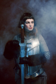 Woman posing in battle armour, studio shot 