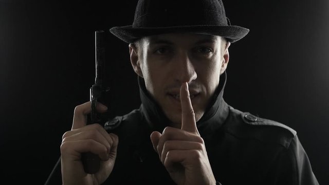 Portrait of a gangster in a hat and a black cloak